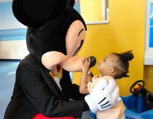 Young patient meets Mickey Mouse at La Rabida Children's Hospital.