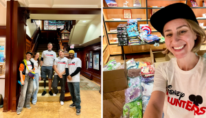 Disney VoluntEARS pose in foyer and in front of packaged Halloween costumes and goodies.