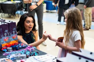 Auliʻi Cravalho makes pinkie promise with patient at Cohen Children's Medical Center