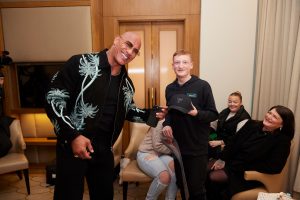 Dwayne Johnson poses with a Make-A-Wish kid.