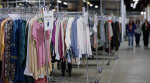 Racks of clothes in a warehouse.