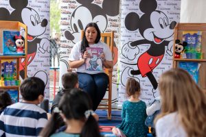 Disney VoluntEAR reads to children