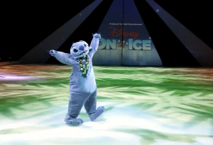 Stitch appears on ice skates on an ice skating rink in front of a sign that reads 