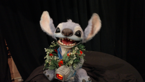Animatronic Stitch holds ticket scanner
