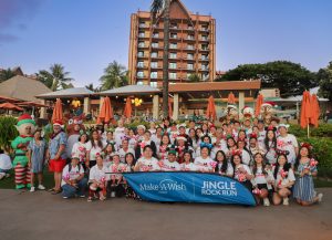 Disney VoluntEARS pose at Aulani with Make-A-Wish sign