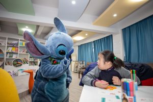 Stitch waves at child