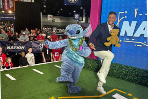 Stitch and Tim Tebow pretend to play football on the set of SEC Nation