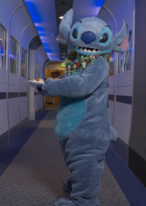 Stitch stand in hallway at Walt Disney Imagineering holding a plate of cookies