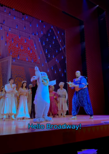 Stitch stands on the stage of Aladdin on Broadway after crashing the show