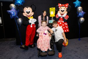 kids at children's hospital pose with Minnie and Mickey Mouse