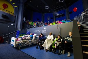 kids and families sit in MediCinema to watch movie together