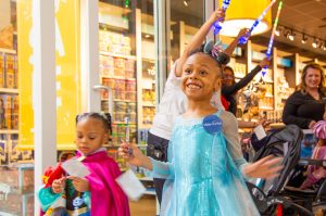 wish kid sisters smile walking out of Disney Store