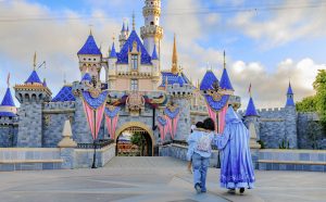 Lilo, her mom and Fairy Godmother walk toward Sleeping Beauty Castle
