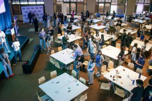 teen students stand around the room mingling