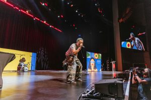 Adrian Lyles sings on stage