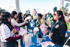 volunteers speak to teens at informational booth