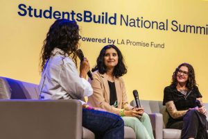 women speakers smile on stage