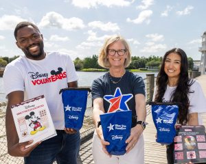 Disney VoluntEARS pose with Blue Star Families kits and materials being donated