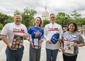 volunteers pose in front of capitol building