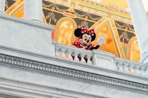 Minnie Mouse waves from upstairs