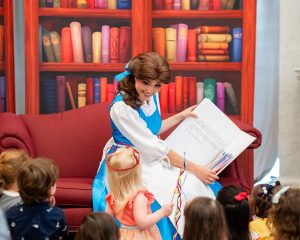 Belle reads book to children