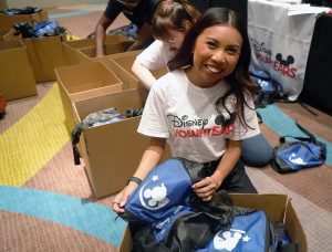 Disney VoluntEAR smiles with MAW kitting materials in hand