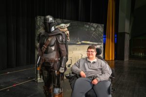 wish kid Alex poses with the Mandalorian