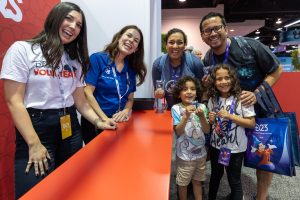 Make-A-Wish and Disney VoluntEARS reps pose with family participating in VoluntEARS Pavillion