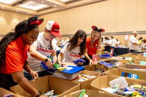 Walt Disney World VoluntEARS pack school supplies for children