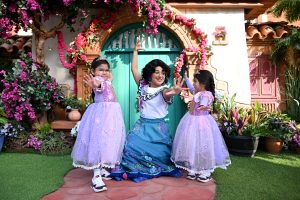 little girls smile and laugh with Mirabel from Disney's Encanto